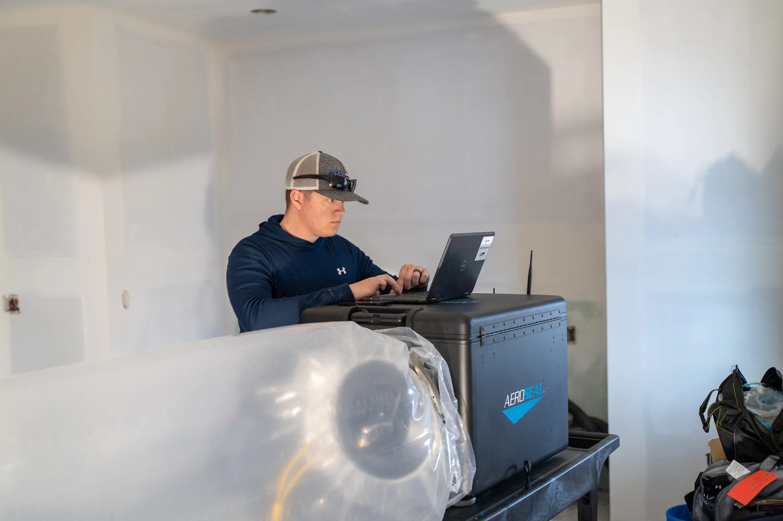 A technician performing Aeroseal duct sealing work